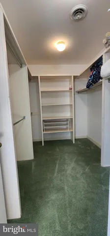 en empty room with windows and fireplace