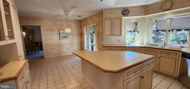 a view of a dining room with furniture and a large window