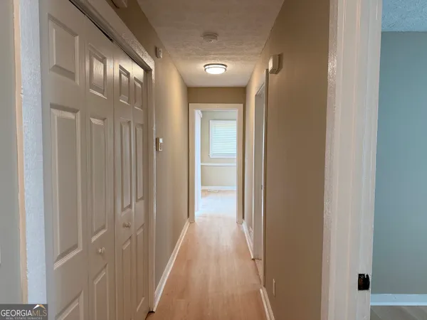 a view of a hallway with wooden floor