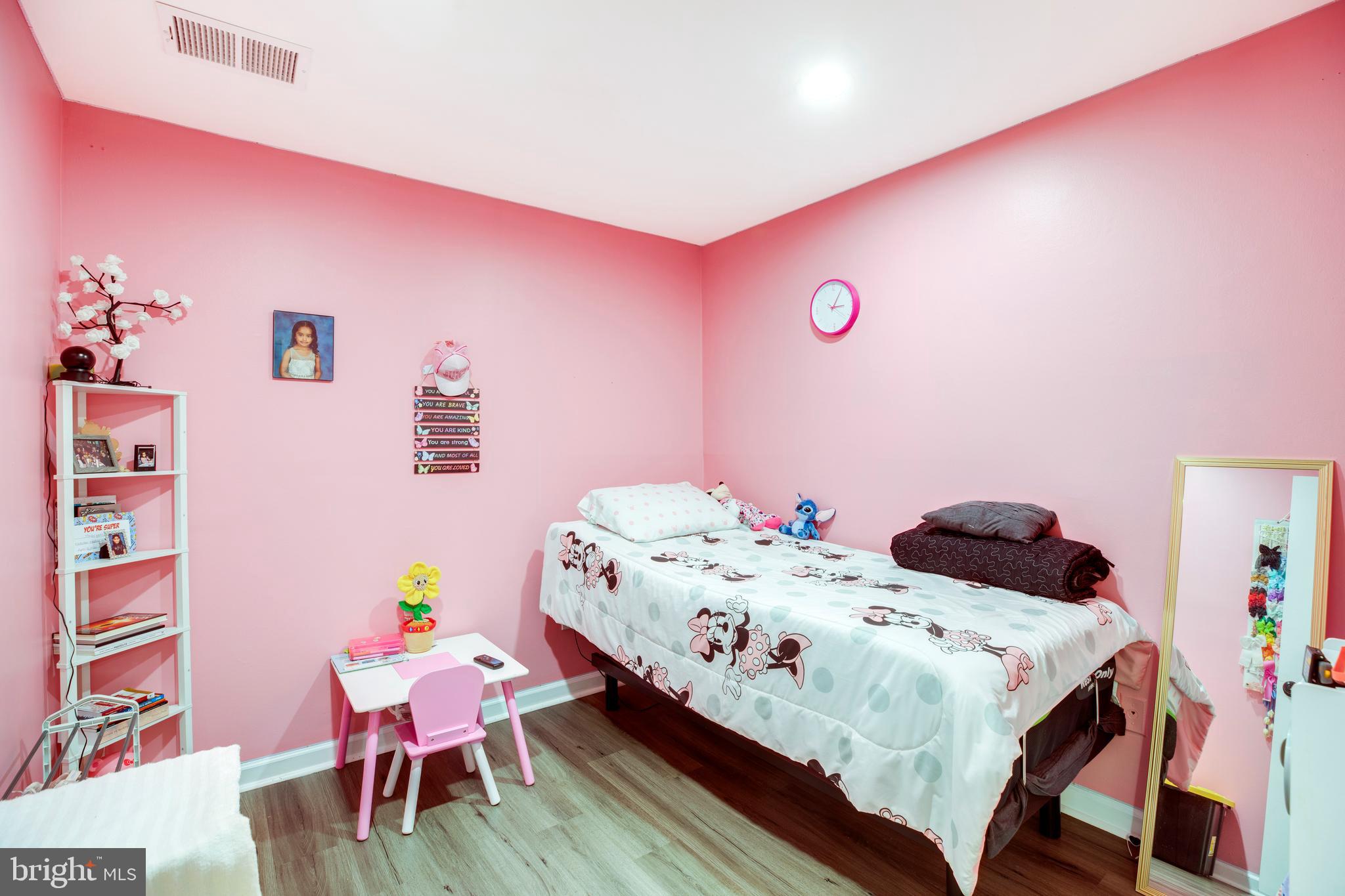 3382 Hewitt Avenue, Unit 102 Silver Spring, MD 20906 - Photo 11 of 22 a bedroom with a bed and a table in it