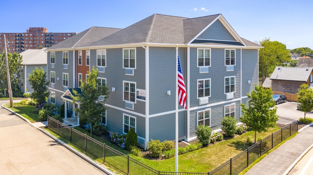 101 California Avenue, Unit 303 Quincy, MA 02169 - Photo 1 of 13 a front view of a house with garden