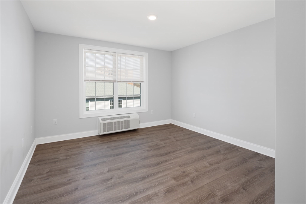 101 California Avenue, Unit 303 Quincy, MA 02169 - Photo 11 of 13 wooden floor in an empty room with a window