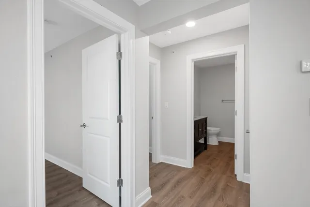 a view of a room with wooden floor
