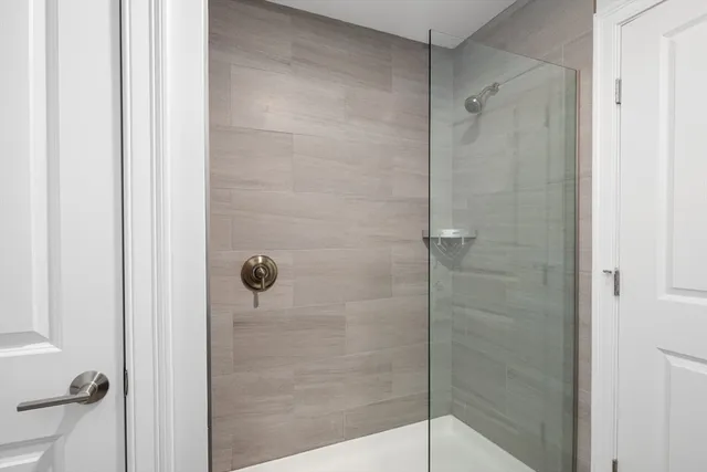 a bathroom with a glass shower door