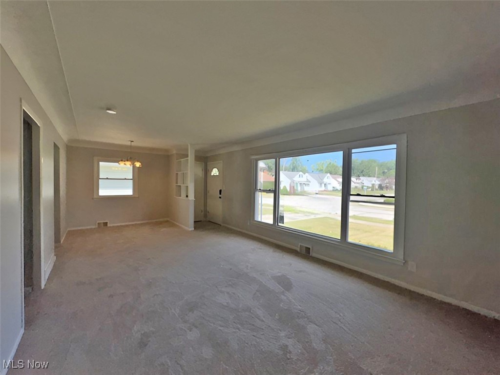 28642 Forest Road Willowick, OH 44095 - Photo 12 of 23 Carpeted empty room featuring baseboards and a chandelier