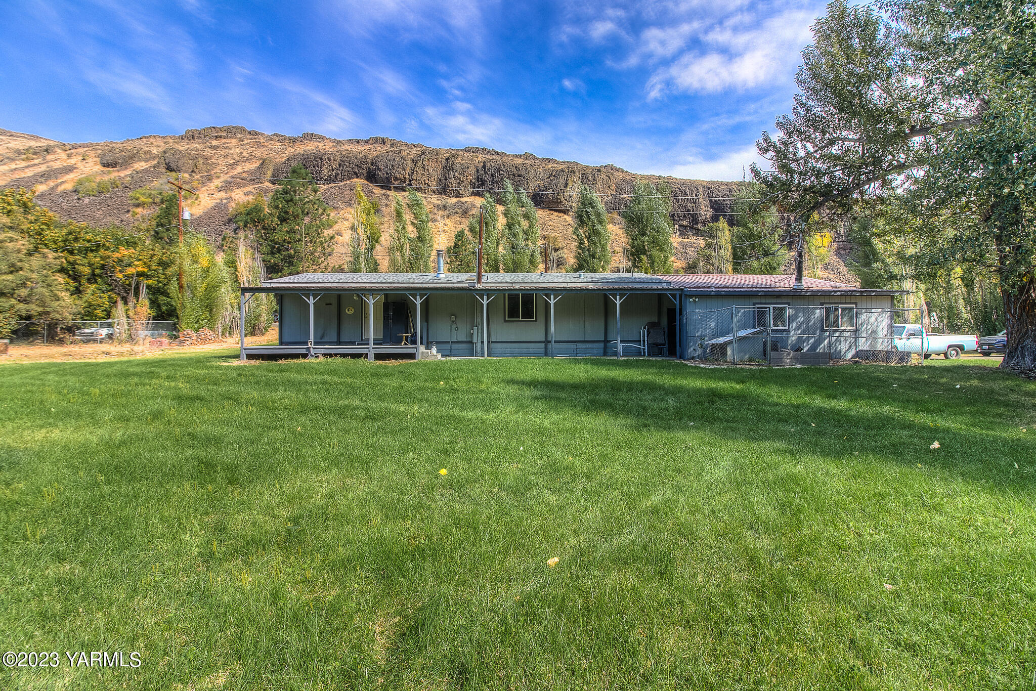 a view of a house with a yard and sitting area