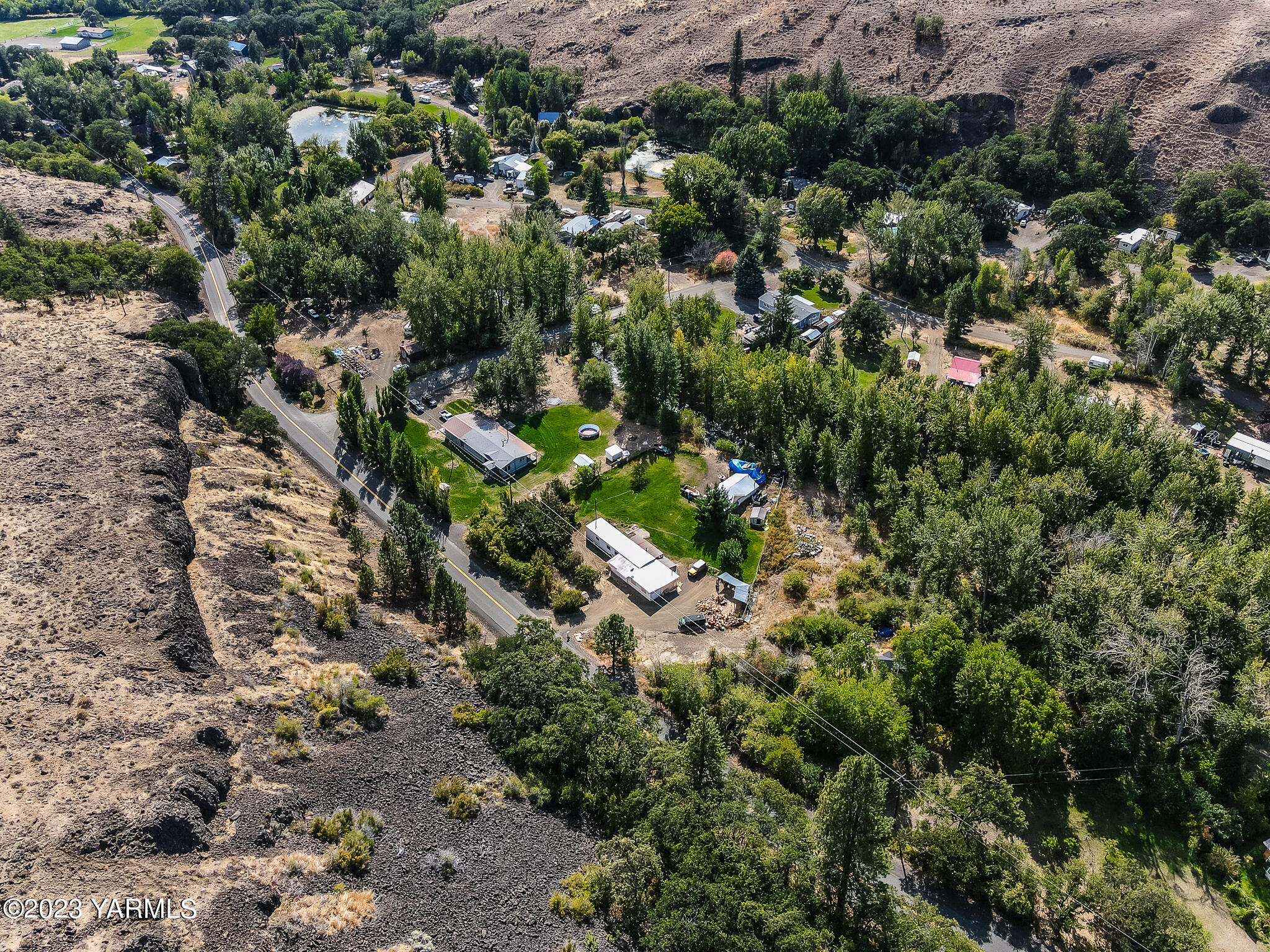 1710 North Fork Road Yakima, WA 98903 - Photo 33 of 34 a view of a house with a lush green forest