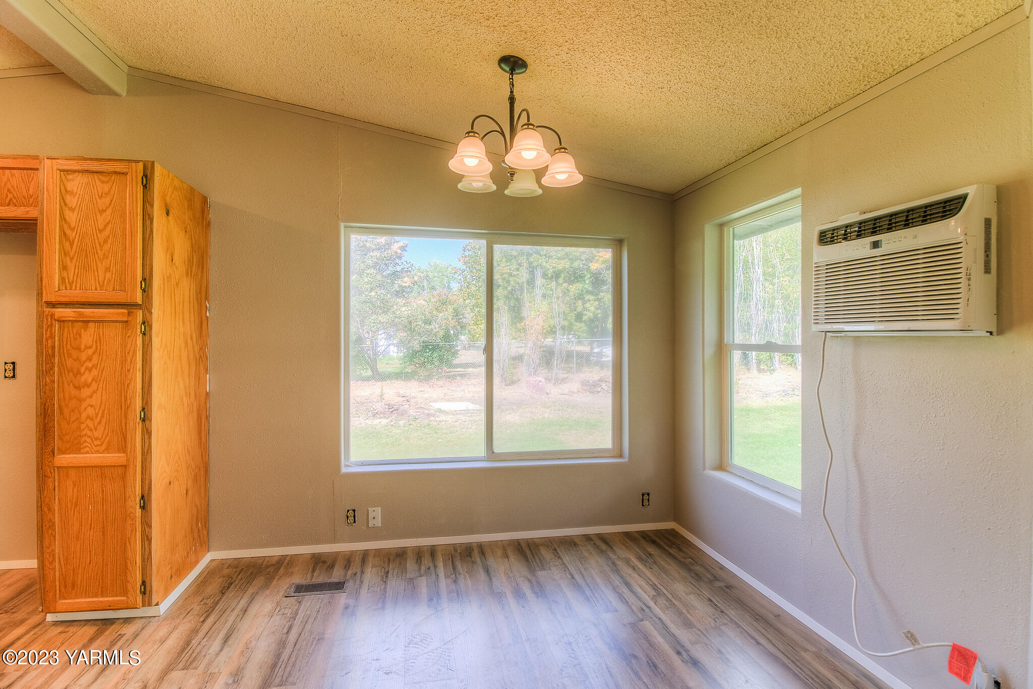 1710 North Fork Road Yakima, WA 98903 - Photo 8 of 34 a view of an empty room with wooden floor and a window