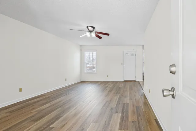 wooden floor in an empty room with a window