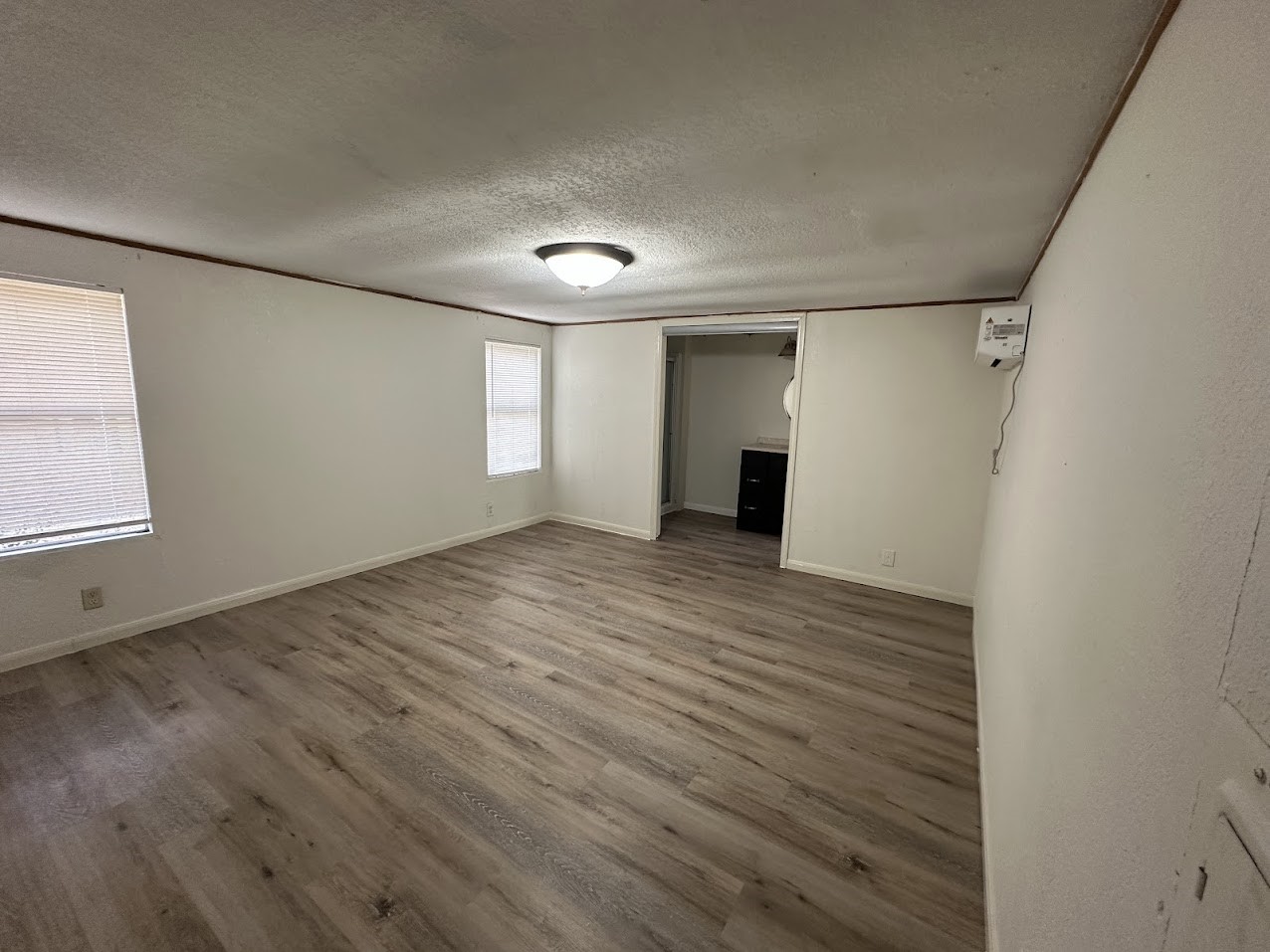 26518 McIntosh Road Magnolia, TX 77355 - Photo 5 of 17 a view of an empty room with wooden floor and a window