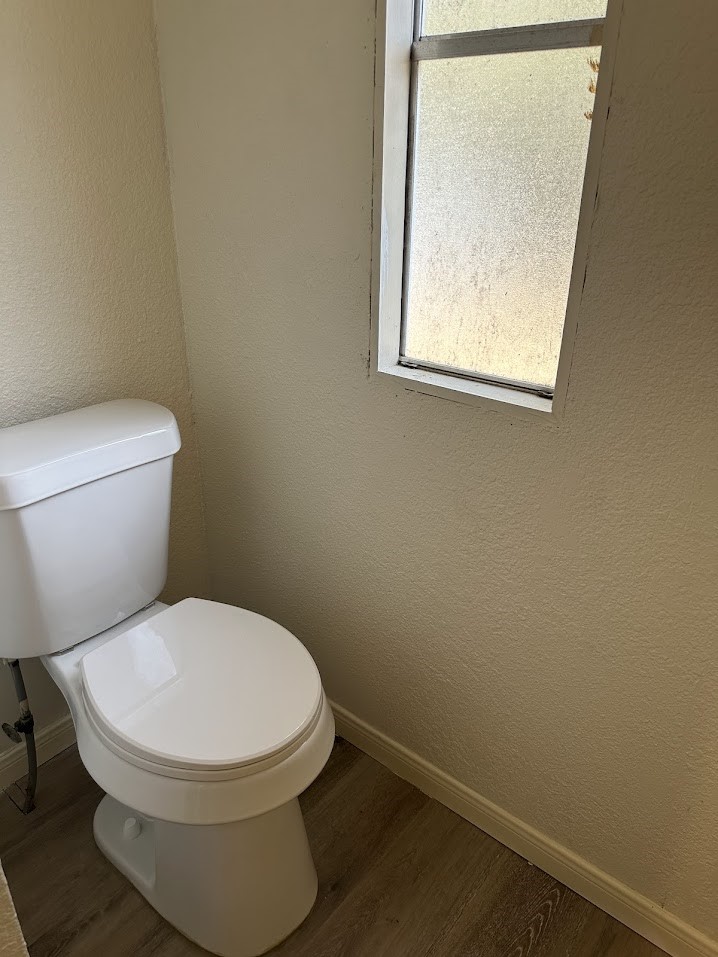 26518 McIntosh Road Magnolia, TX 77355 - Photo 9 of 17 a white toilet sitting next to a small window