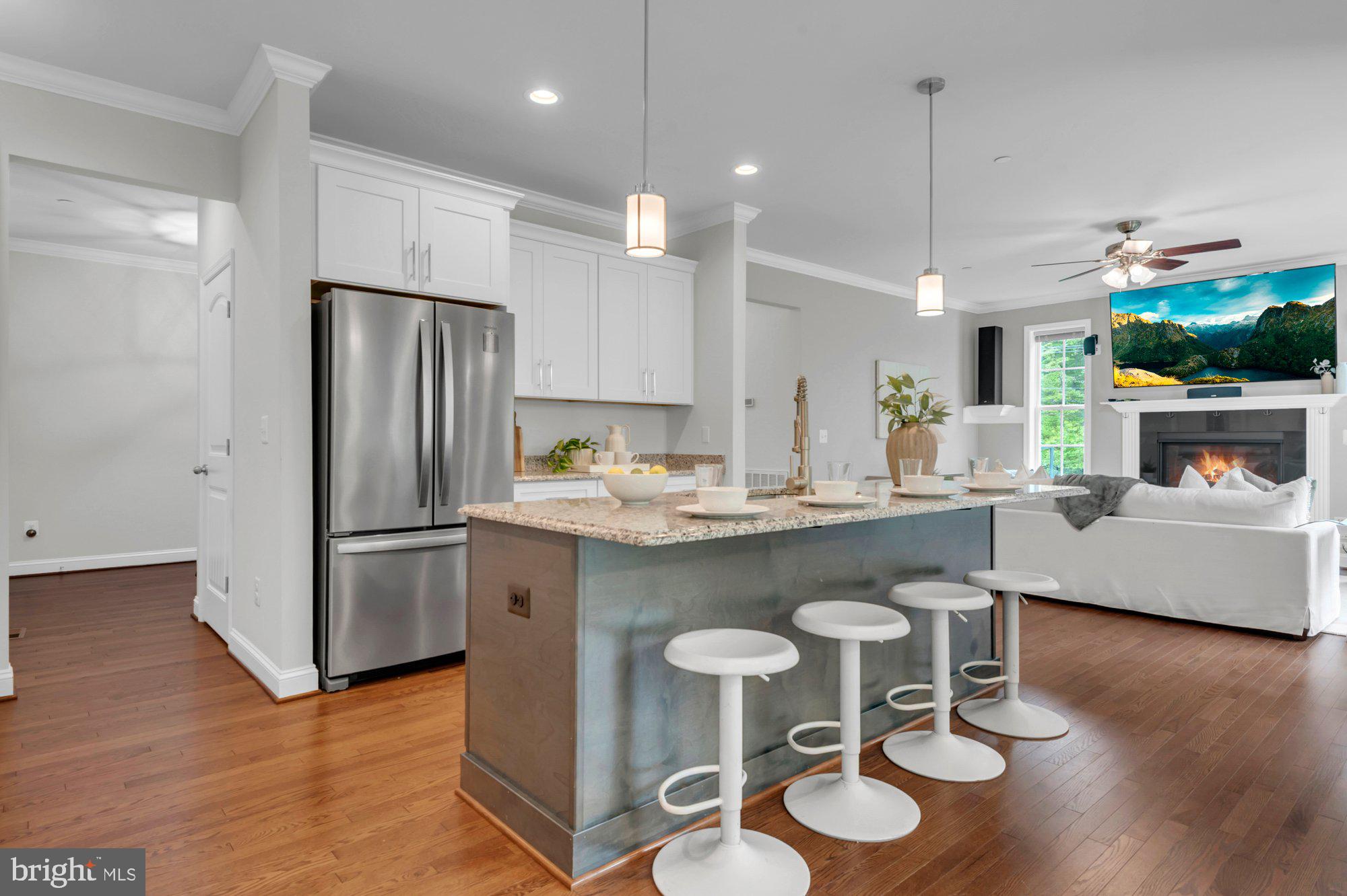 505 Brewerton Lane Edgewater, MD 21037 - Photo 14 of 78 a kitchen with stainless steel appliances granite countertop a refrigerator a sink a stove a dining table and chairs with wooden floor