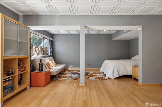 a view of a room that has a bed and glass door