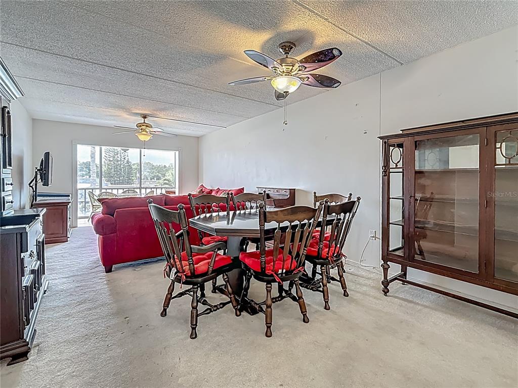 1 Boca Ciega Point Boulevard, Unit 215 St. Petersburg, FL 33708 - Photo 11 of 39 a view of a dining room with furniture window and outside view