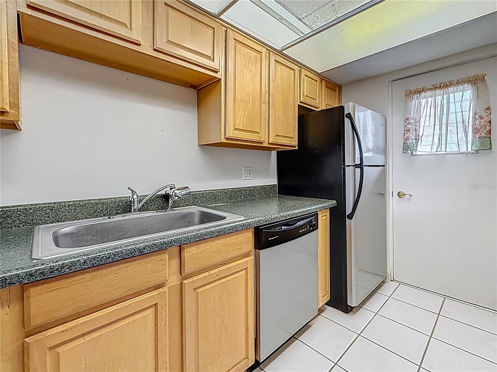 1 Boca Ciega Point Boulevard, Unit 215 St. Petersburg, FL 33708 - Photo 16 of 39 a kitchen with stainless steel appliances granite countertop a sink stove and refrigerator