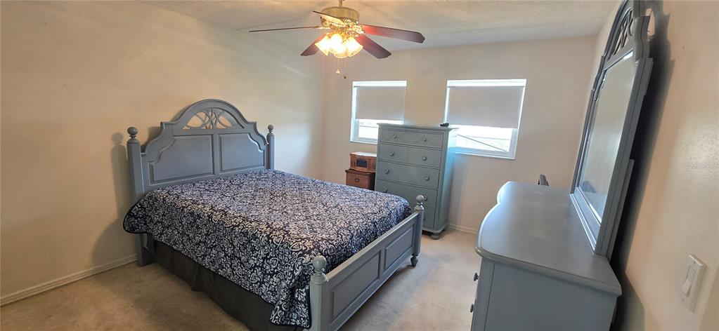 1 Boca Ciega Point Boulevard, Unit 215 St. Petersburg, FL 33708 - Photo 18 of 39 a bedroom with a bed and a dresser