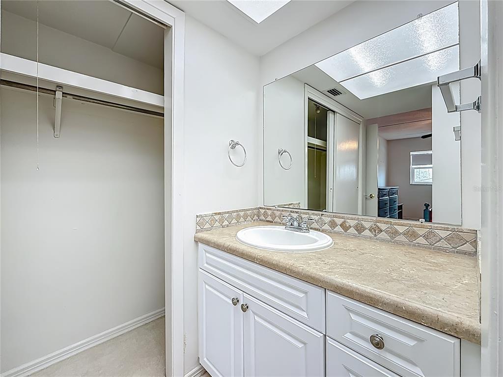 1 Boca Ciega Point Boulevard, Unit 215 St. Petersburg, FL 33708 - Photo 20 of 39 a bathroom with a granite countertop sink and a mirror