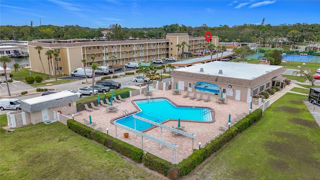 1 Boca Ciega Point Boulevard, Unit 215 St. Petersburg, FL 33708 - Photo 2 of 39 an aerial view of a house with swimming pool and a yard