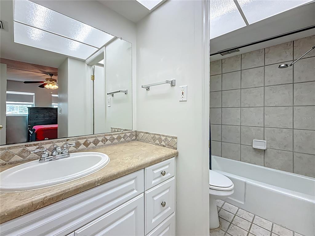 1 Boca Ciega Point Boulevard, Unit 215 St. Petersburg, FL 33708 - Photo 21 of 39 a bathroom with a sink a toilet and shower