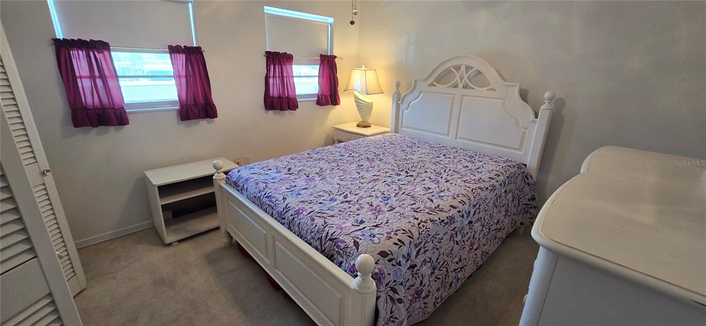 1 Boca Ciega Point Boulevard, Unit 215 St. Petersburg, FL 33708 - Photo 23 of 39 a bed room with a bed and a television