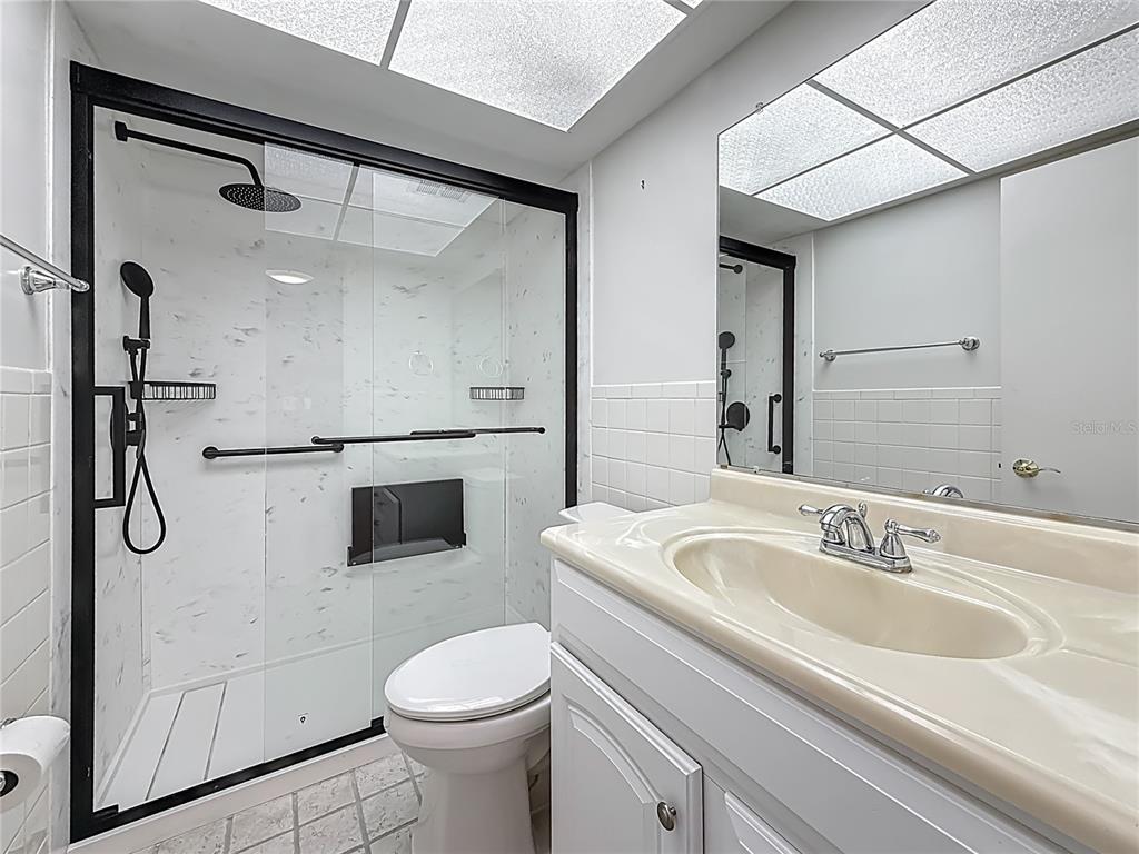 1 Boca Ciega Point Boulevard, Unit 215 St. Petersburg, FL 33708 - Photo 25 of 39 a bathroom with a sink toilet and shower