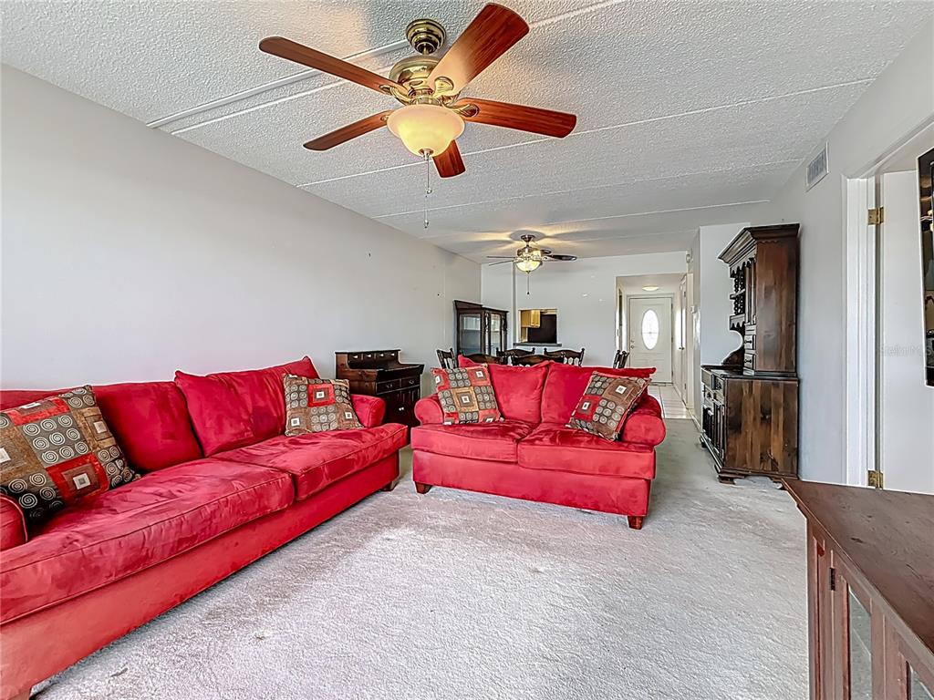 1 Boca Ciega Point Boulevard, Unit 215 St. Petersburg, FL 33708 - Photo 9 of 39 a living room with furniture and a ceiling fan