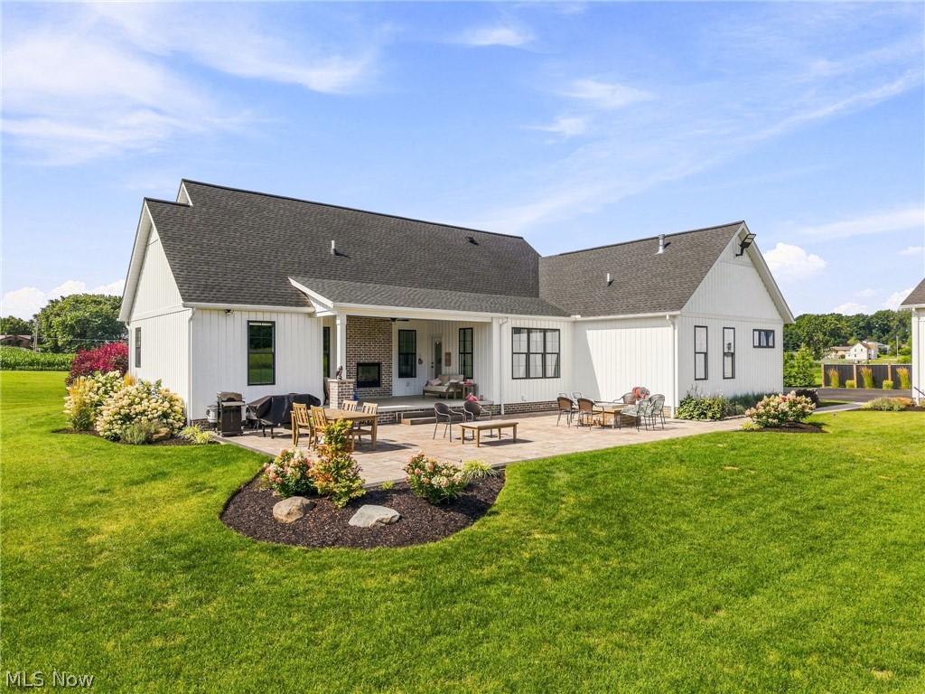 421 Pontius Road Mogadore, OH 44260 - Photo 37 of 50 Expansive exterior featuring a covered patio, paved outdoor living area, and manicured lawn