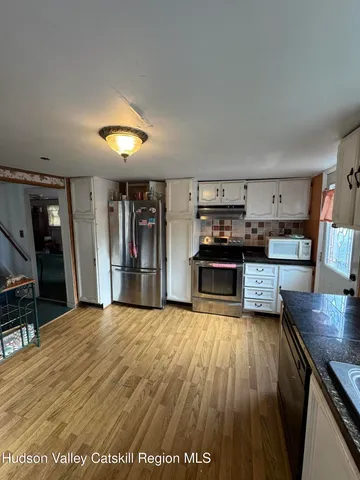 a view of kitchen with cabinets and wooden floor