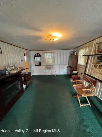 a living room with furniture pool table and chairs