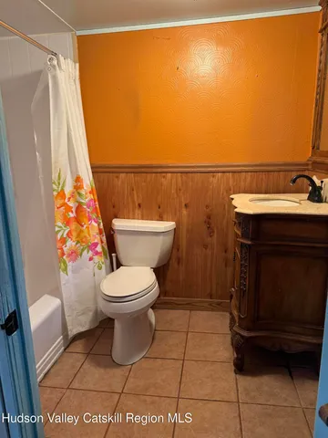 a bathroom with a toilet a sink and a shower