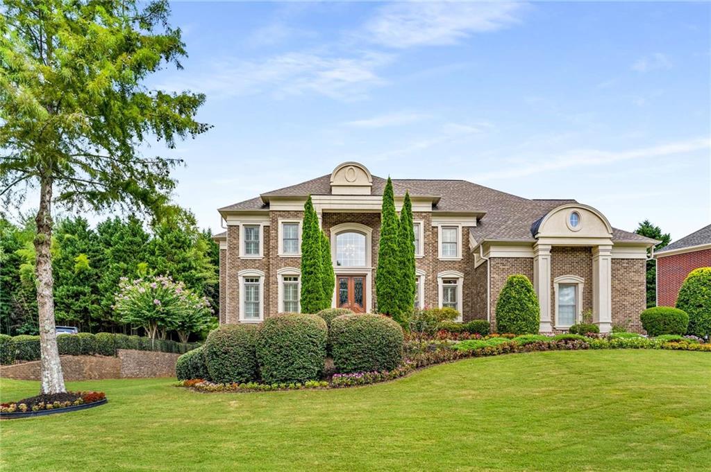 a front view of a house with a garden
