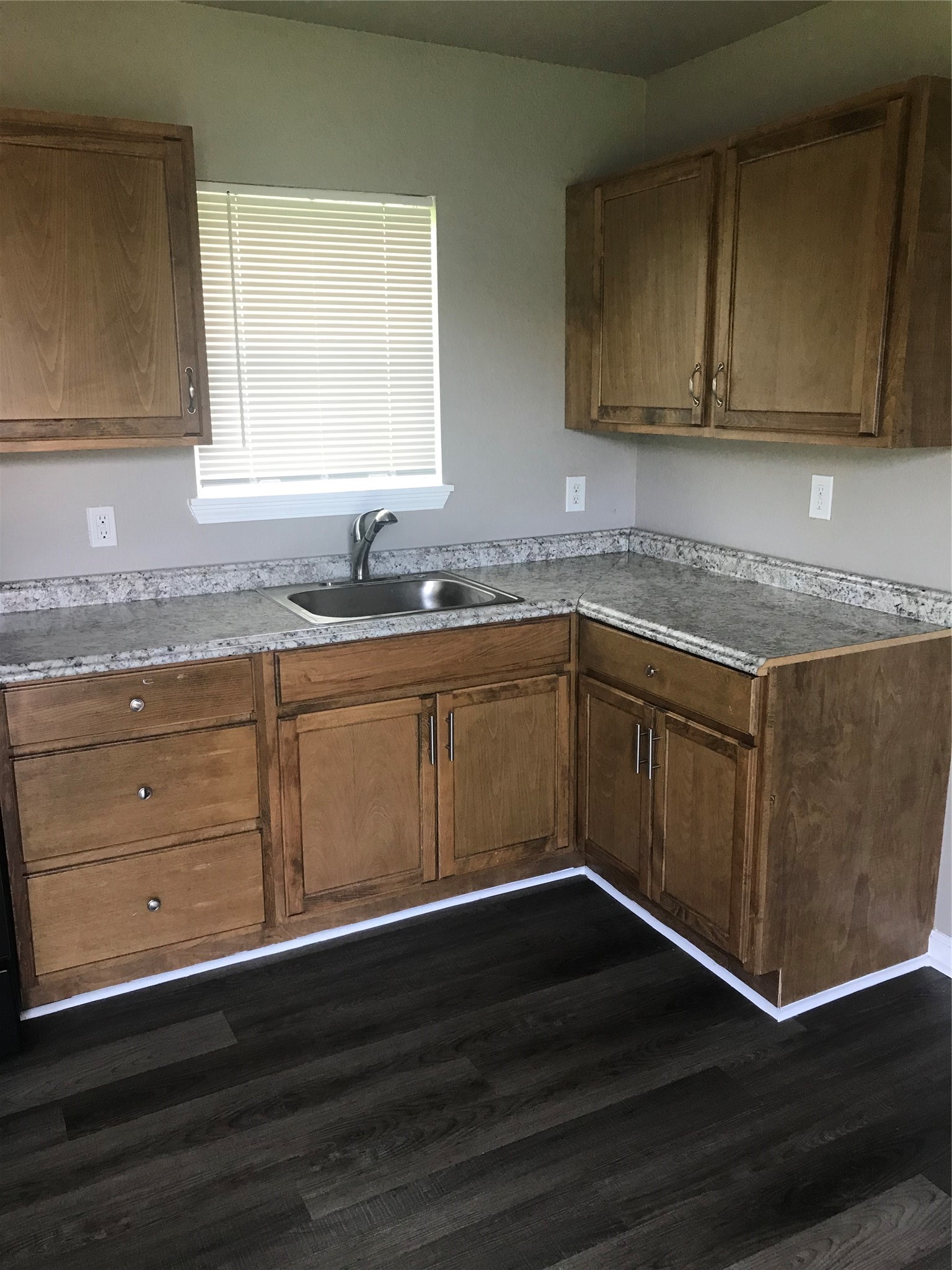 1713 West 5th Street Freeport, TX 77541 - Photo 3 of 11 a kitchen with granite countertop wooden cabinets a sink and dishwasher