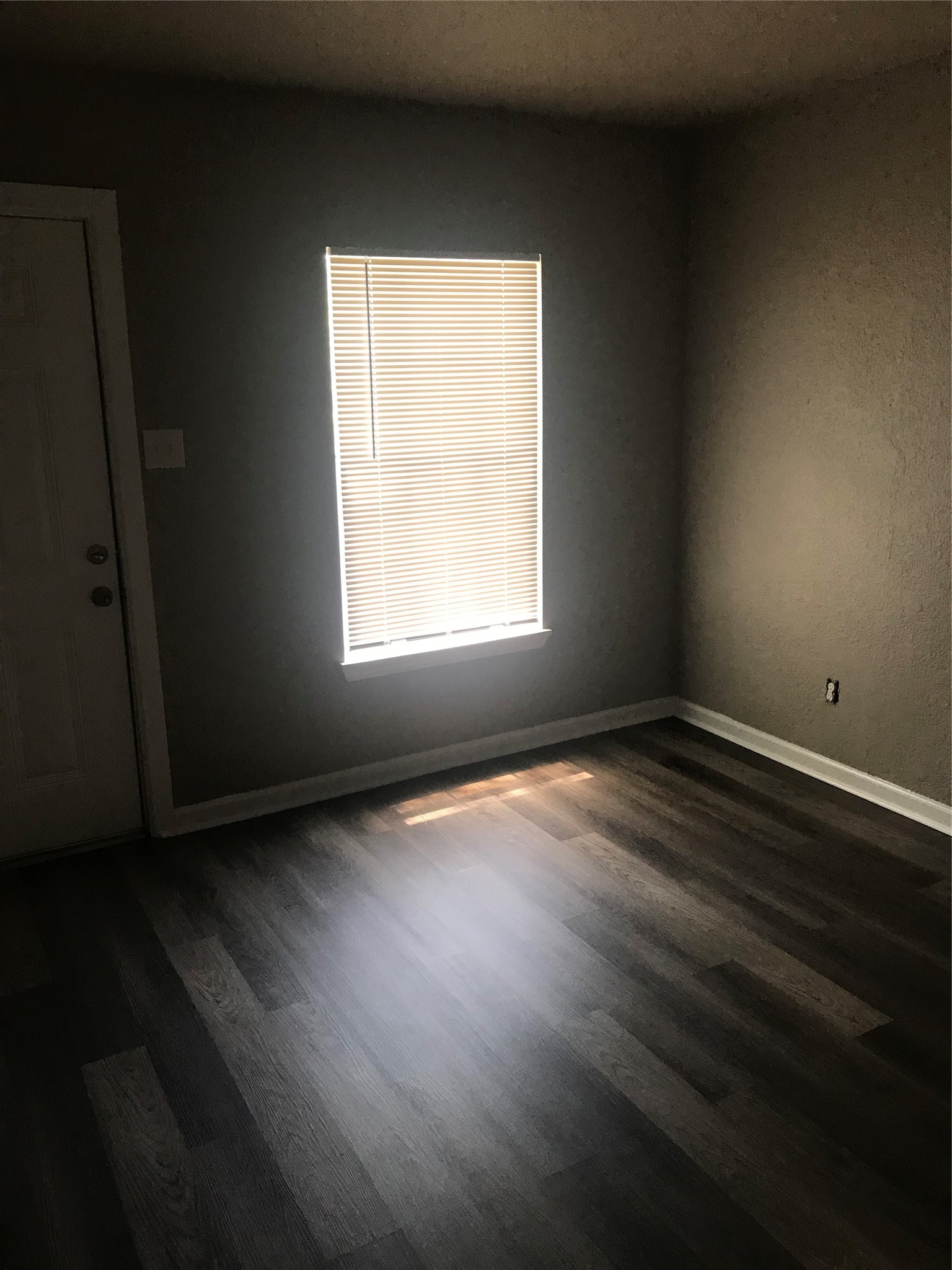 1713 West 5th Street Freeport, TX 77541 - Photo 4 of 11 an empty room with wooden floor and windows