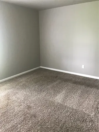 a view of backyard of house with green space