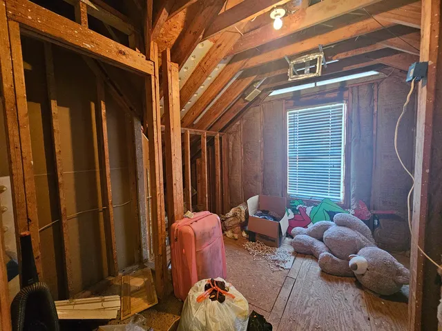 a bedroom with a bed and a mirror