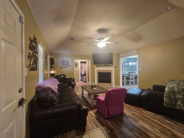 a living room with furniture fireplace and a lamp