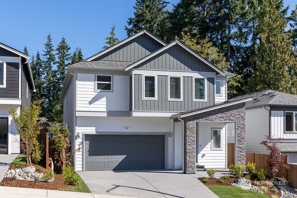 621 215th Street Southeast, Unit RM21 Bothell, WA 98021 - Photo 1 of 29 a front view of a house with garden
