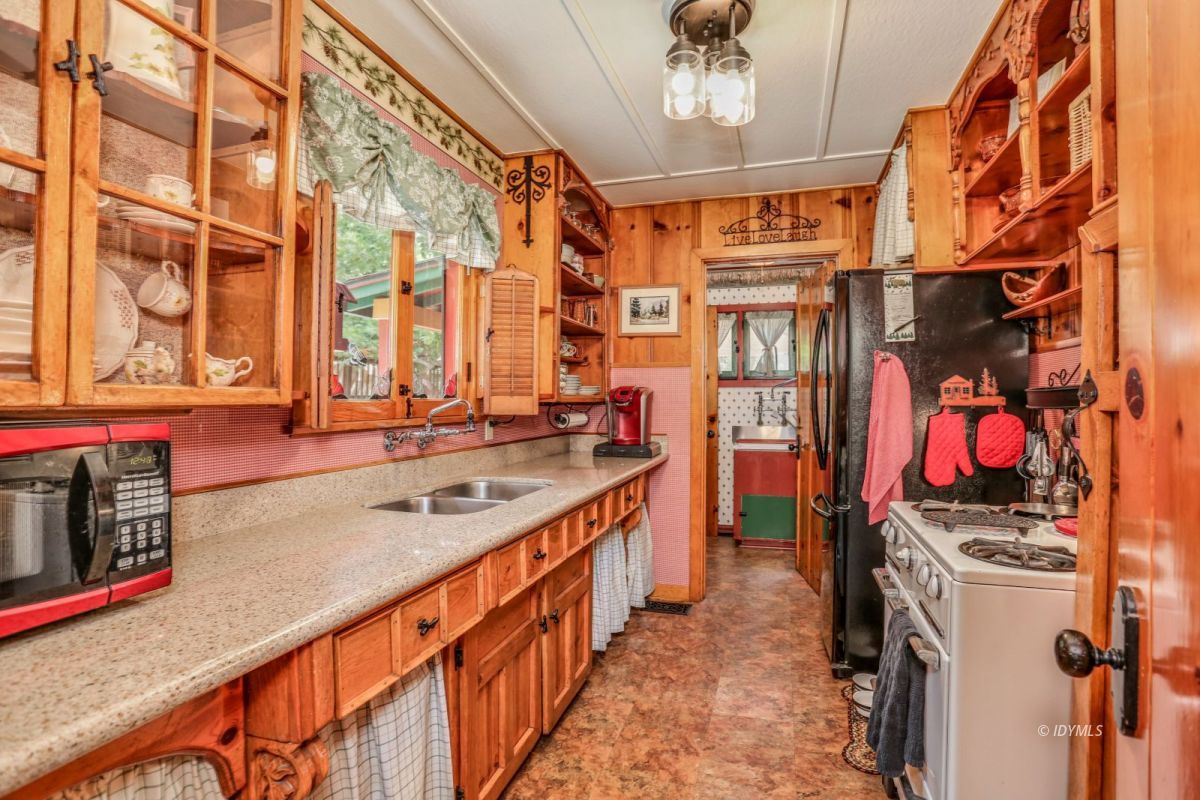 55255 Daryll Road Idyllwild, CA 92549 - Photo 13 of 41 a view of a kitchen with stainless steel appliances granite countertop a sink and wooden cabinets