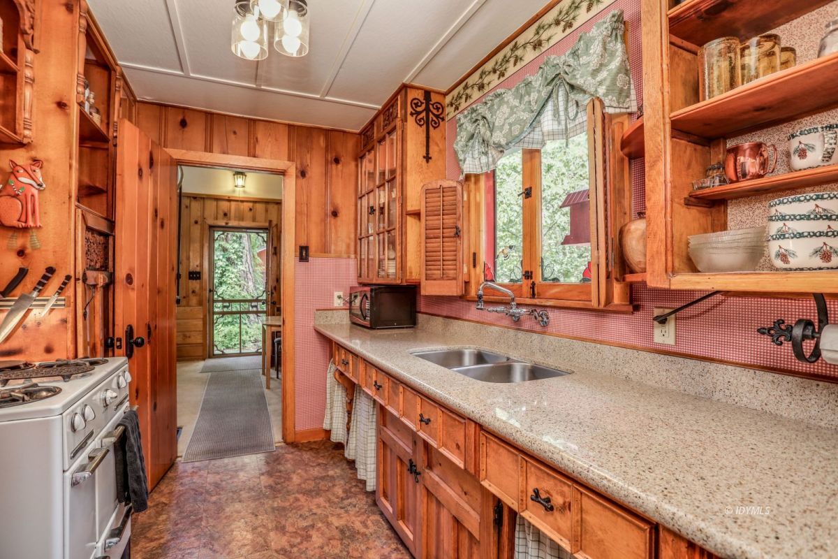 55255 Daryll Road Idyllwild, CA 92549 - Photo 15 of 41 a large kitchen with stainless steel appliances a sink and a large window