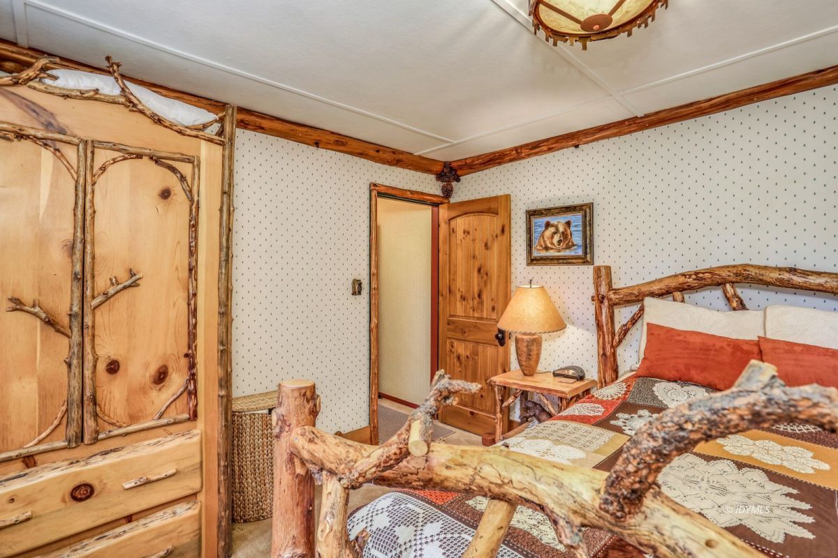 55255 Daryll Road Idyllwild, CA 92549 - Photo 18 of 41 a bed room with a bed and a mirror