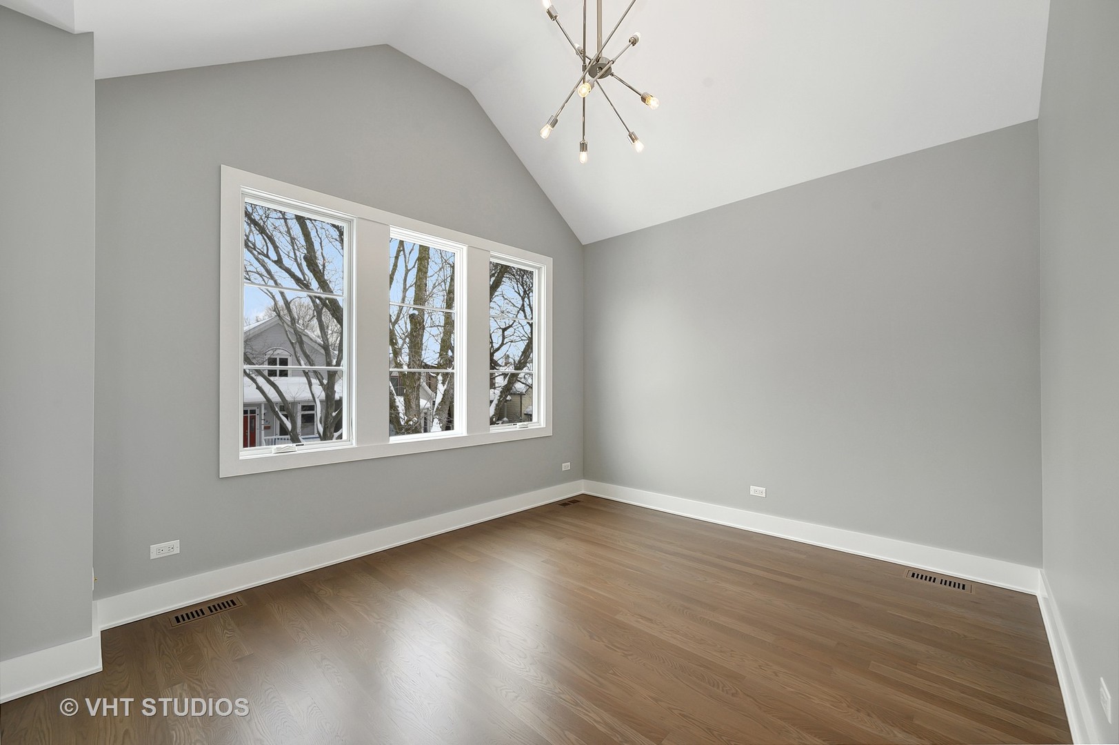 3712 North Marshfield Avenue Chicago, IL 60613 - Photo 16 of 21 a view of an empty room with wooden floor and a window