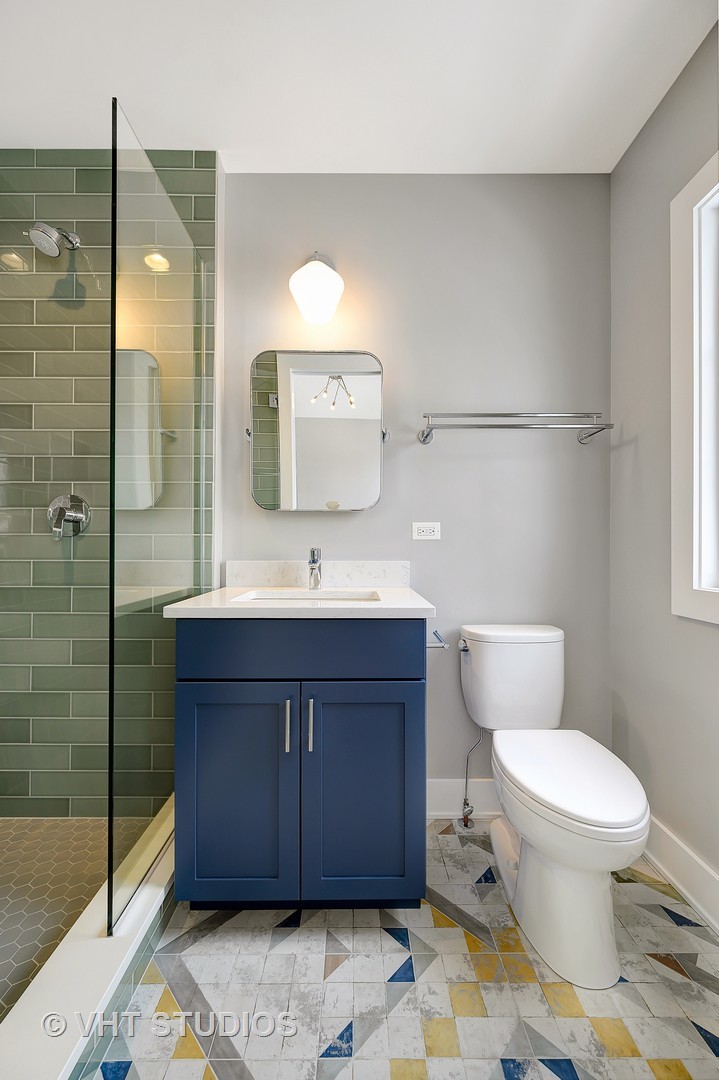 3712 North Marshfield Avenue Chicago, IL 60613 - Photo 19 of 21 a bathroom with a sink a toilet and shower