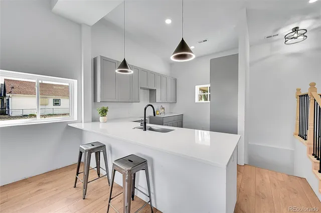 a kitchen with stainless steel appliances a table chairs and a refrigerator