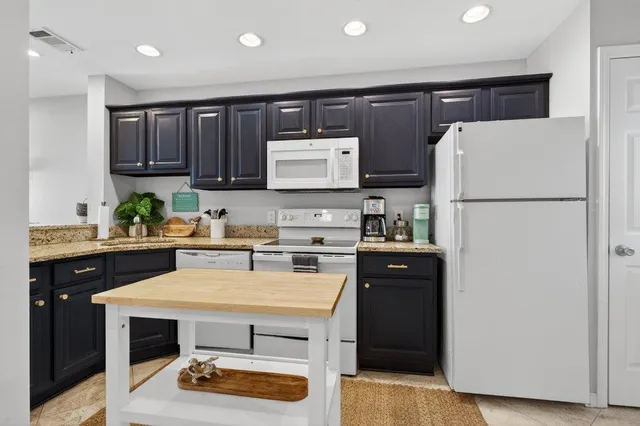 a kitchen with stainless steel appliances granite countertop a sink and a granite counter tops