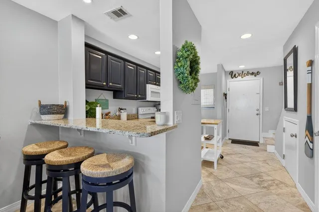a kitchen with wooden cabinets and white appliances