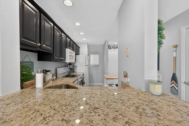a kitchen with a refrigerator a stove a sink and a cabinets