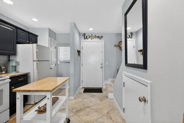 a kitchen with a refrigerator and a stove