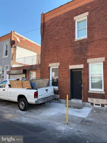 a car parked in front of a brick building