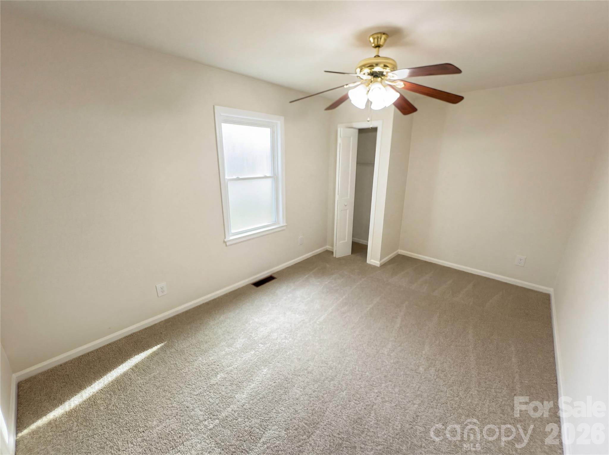 633 Briarcliff Road Rock Hill, SC 29730 - Photo 4 of 14 an empty room with windows and chandelier fan