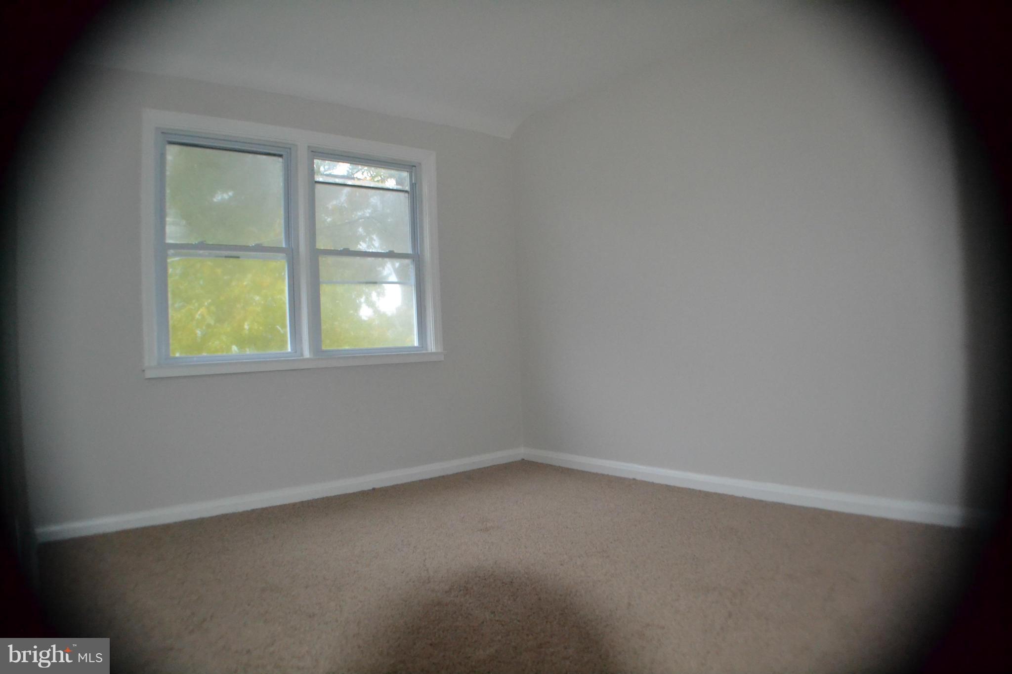 1424 Cedarcroft Road Baltimore, MD 21239 - Photo 11 of 16 an empty room with a window